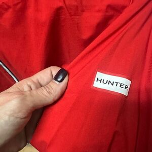 Red hunter packable wind breaker with hood  youth size XL